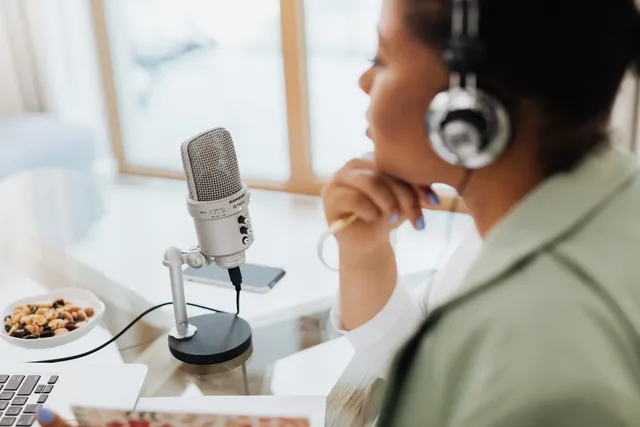 Creator podcasting into a studio microphone